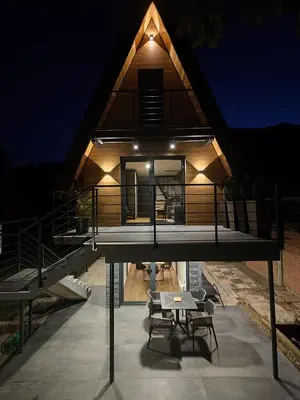 a house with a deck with a table and chairs at Vikendica Villa Natasa in Banja Luka