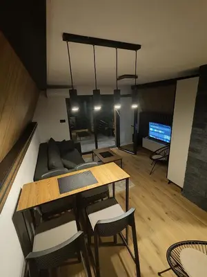 a living room with a couch and a table at Vikendica Villa Natasa in Banja Luka