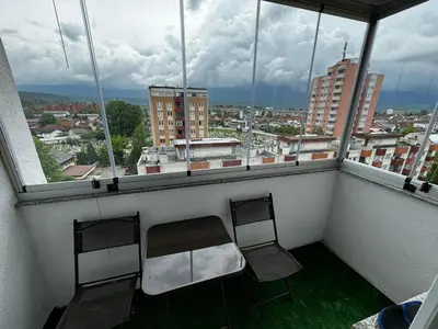 two chairs on a balcony with a view of a city at Asya Art in Bihać