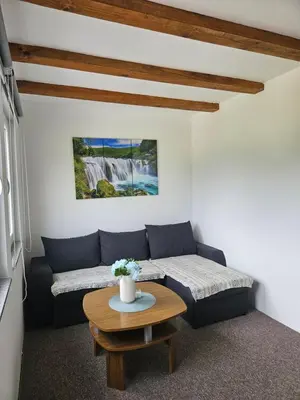 a living room with a couch and a table at Seosko domaćinstvo Bajbut in Bihać