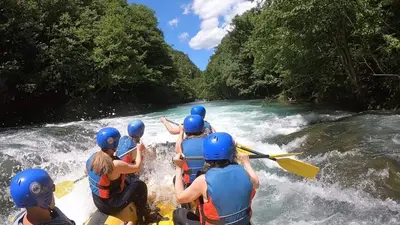 a group of people rafting on a river at Seosko domaćinstvo Bajbut in Bihać
