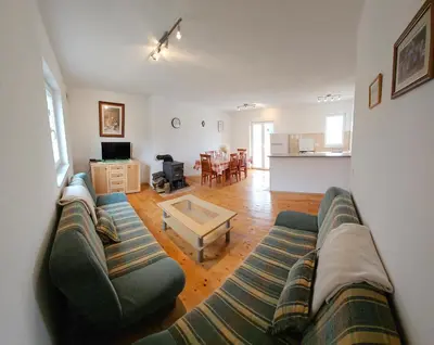 a living room with a couch and a table at Livanjsko Polje Cottage #14 in Lusnić