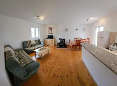 a living room with two couches and a kitchen at Livanjsko Polje Cottage #14 in Lusnić