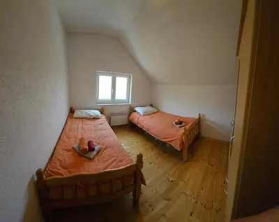 a bedroom with two beds and a window at Livanjsko Polje Cottage #14 in Lusnić