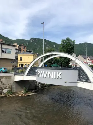 a bridge over a river with a sign on it at Travnik Nostalgia Apartment in Travnik