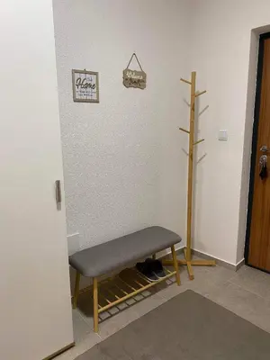 a room with a bench and a sign on the wall at Travnik Nostalgia Apartment in Travnik
