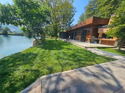 a house on the shore of a body of water at Villa Vigo in Bosanska Krupa