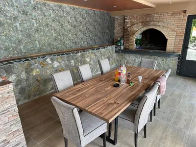 a wooden table in a kitchen with chairs around it at Villa Vigo in Bosanska Krupa