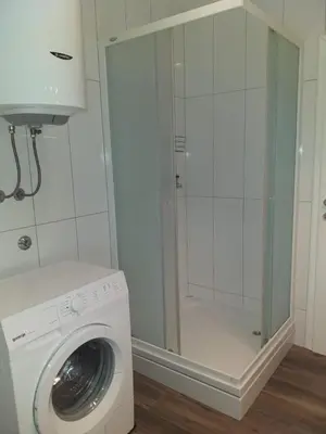 a washing machine in a bathroom with a shower at Ivan in Livno
