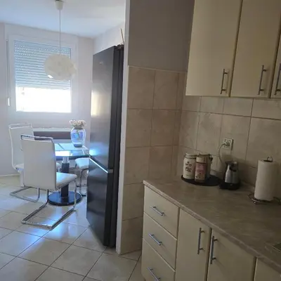 a kitchen with a black refrigerator and a table at Alex Bl in Banja Luka