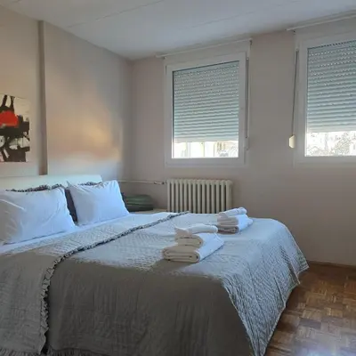 a bedroom with a bed with towels on it at Alex Bl in Banja Luka