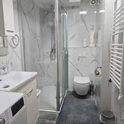 a bathroom with a shower and a toilet and a sink at Alex Bl in Banja Luka