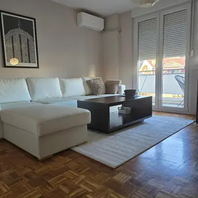 a living room with a white couch and a coffee table at Alex Bl in Banja Luka