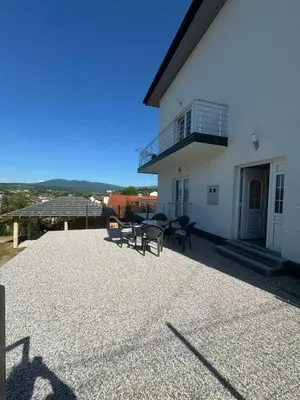 a patio with tables and chairs in front of a building at Apartment BORICI in Bihać