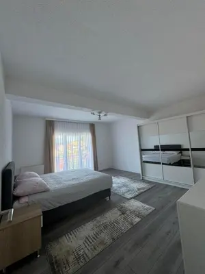 a bedroom with a bed and a large window at Apartment BORICI in Bihać