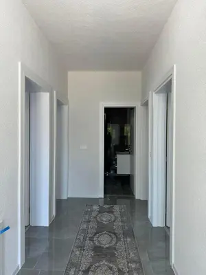 a hallway with two doors and a rug on the floor at Apartment BORICI in Bihać