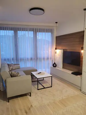 a living room with a couch and a tv at Banja Apartman in Tuzla