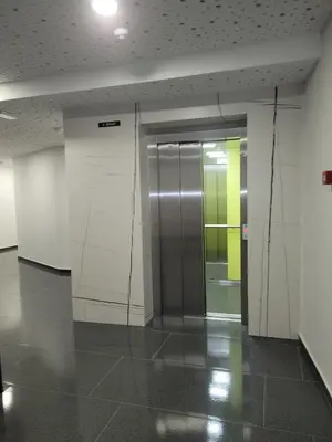 a hallway with a elevator in a building at Banja Apartman in Tuzla