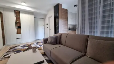 a living room with a couch and a table at Banja Apartman in Tuzla