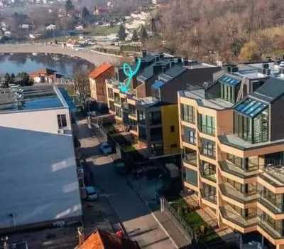 an aerial view of a city with buildings and a river at Banja Apartman in Tuzla