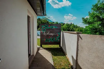 a garden entrance to a house with a welcome sign at Kuća za odmor Vučjak in Bihać