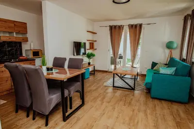 a living room with a table and a blue couch at Kuća za odmor Vučjak in Bihać