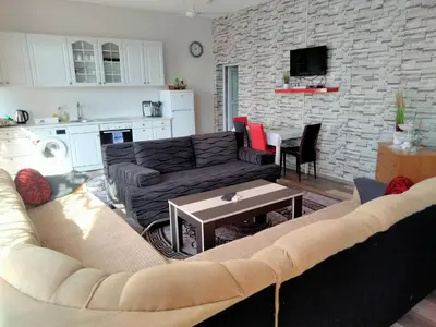 a living room with a couch and a table at Kumalic 2 in Sanski most