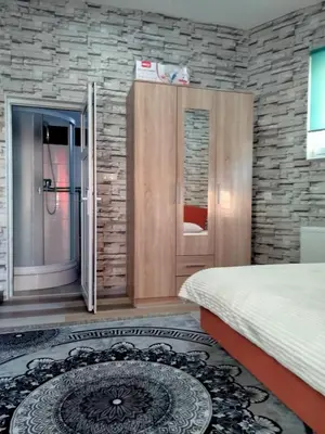 a bedroom with a bed and a bathroom with a shower at Kumalic 2 in Sanski most