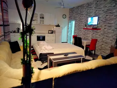 a living room with a bed and a table at Kumalic 2 in Sanski most