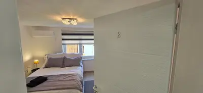 a room with a bed and a window and a door at Apartmani Teša in Tešanj