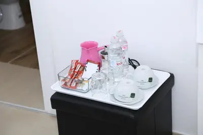 a table with a bunch of glass items on it at Apartmani Teša in Tešanj