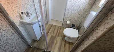 a small bathroom with a toilet and a sink at Apartmani Teša in Tešanj