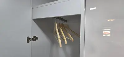 a closet with baseball bats hanging from a door at Apartmani Teša in Tešanj