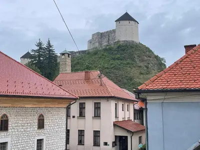 a castle on top of a hill with roofs at Apartmani Teša in Tešanj
