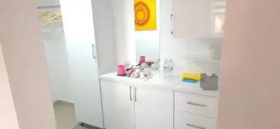 a white kitchen with white cabinets and a sink at Apartmani Teša in Tešanj