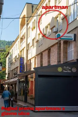 a red circle is on the side of a building at Apartment Stari Grad Korzo Tuzla in Tuzla