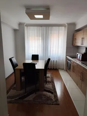 a kitchen with a table and chairs in a room at Apartment Stari Grad Korzo Tuzla in Tuzla