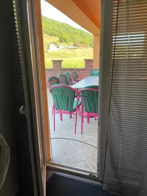 a patio with a table and chairs on a porch at Villa Kula Bihac in Orašac