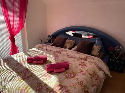 a bedroom with a large bed with two pillows on it at Villa Kula Bihac in Orašac