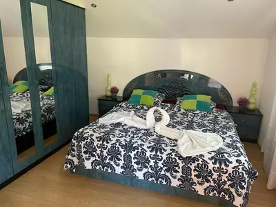 a bedroom with a bed and a large mirror at Villa Kula Bihac in Orašac