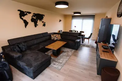a living room with a leather couch and a table at Casa Lumi in Bugojno