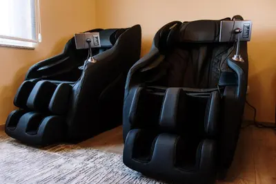 two black leather chairs sitting next to a wall at Casa Lumi in Bugojno