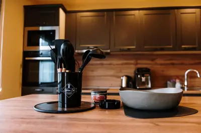 a kitchen counter with a cup with utensils on it at Casa Lumi in Bugojno