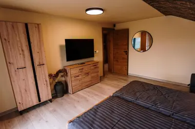 a bedroom with a television and a dresser with a mirror at Casa Lumi in Bugojno