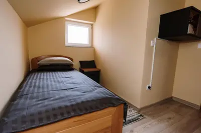 a bed in a small room with a window at Casa Lumi in Bugojno
