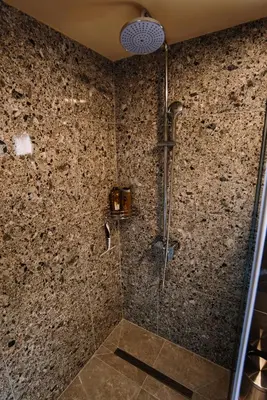 a bathroom with a shower with a glass door at Casa Lumi in Bugojno