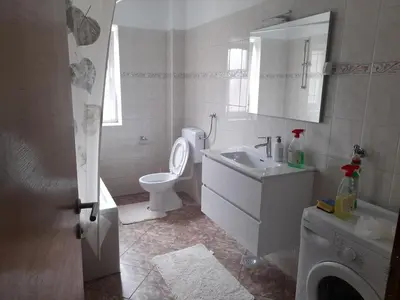 a white bathroom with a toilet and a sink at Apartman Zoran in Livno