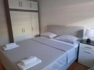 a bedroom with a bed with two towels on it at Apartman Zoran in Livno