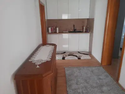 a small room with a bench and a sink at Apartman Zoran in Livno
