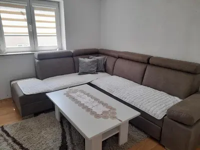 a living room with a couch and a coffee table at Apartman Zoran in Livno